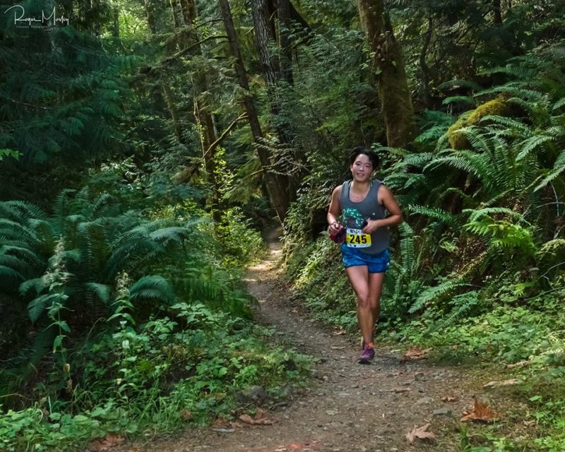 A runner on a wooded trail during GOAT Run