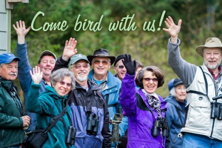A group of birders with binoculars waving at the camera