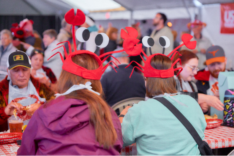 Dungeness Crab & Seafood Festival goers wearing crab hats and eating in Port Angeles, WA on the Olympic Peninsula
