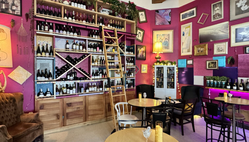 Inside PNWonderland Wine in downtown Port Angeles WA with its cheery pink and very girly atmosphere hosts fun events every week