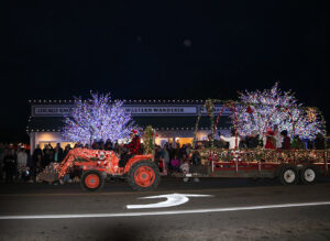 Photo of a tractor pulling a Christmas themed float during Sequim's annual Holiday Tractor Cruise on the Olympic Peninsula