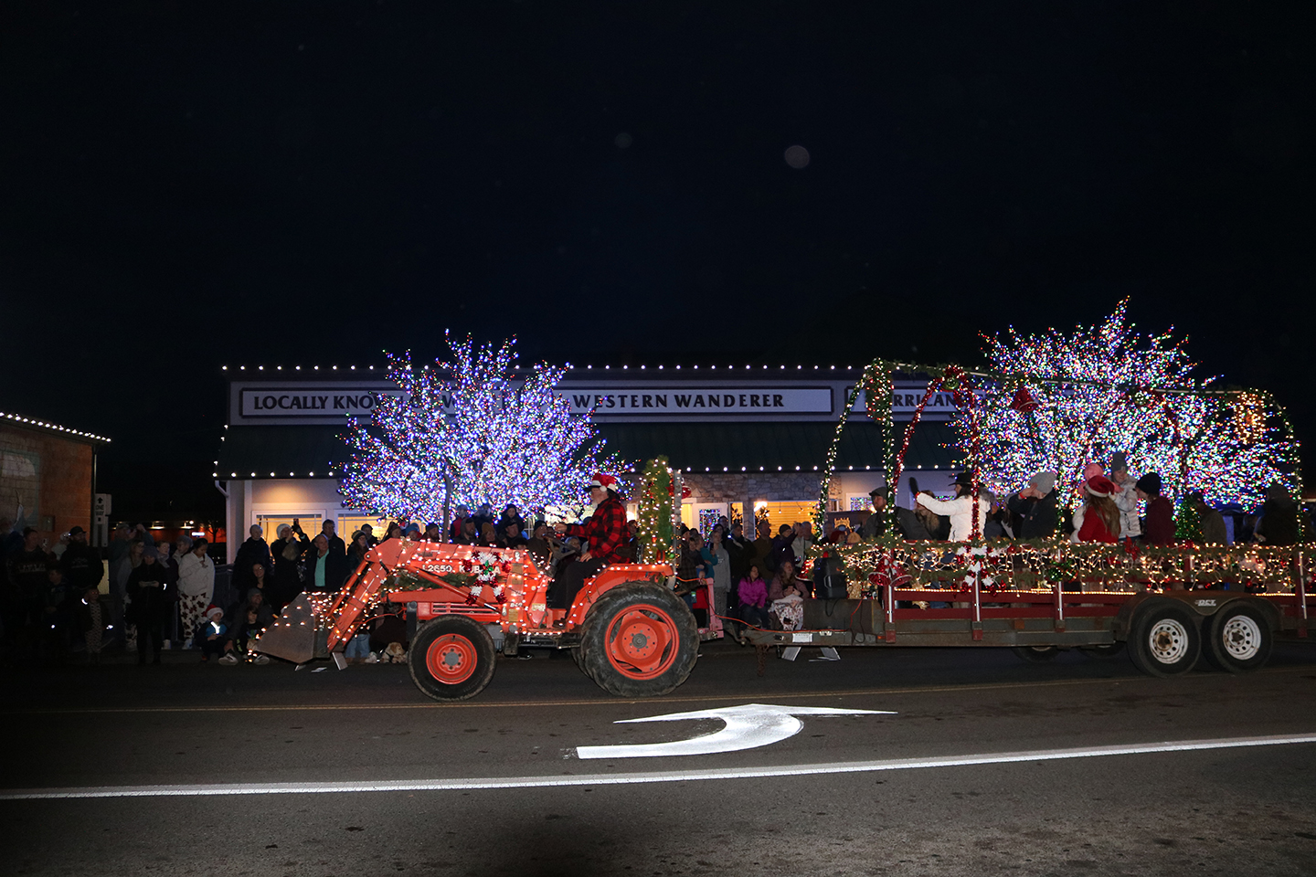 Photo of a tractor pulling a trailer with Christmas lights at the Sequim Holiday Tractor Parade - Discover Winter Wonders All Around the Olympic Peninsula