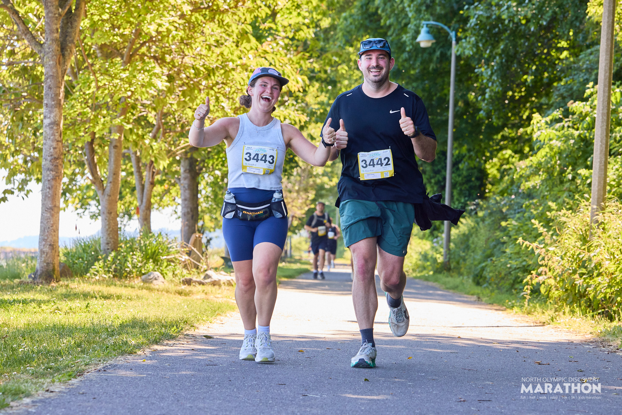 Photo of North Olympic Discovery Marathon participants running and smiling during the race