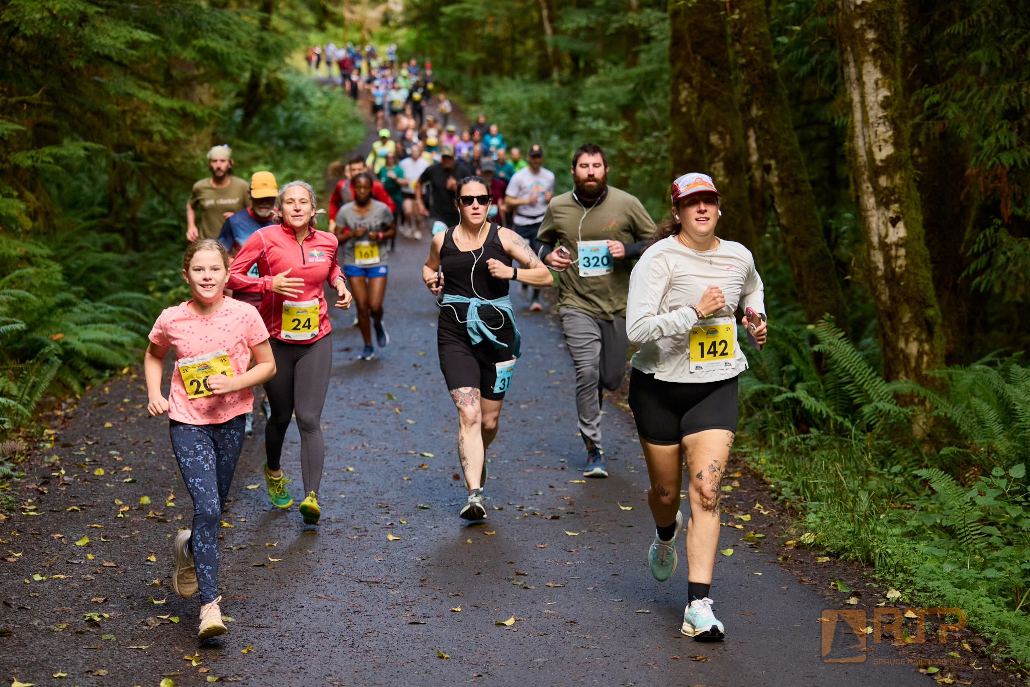 Run The Peninsula Race Series Spruce Railroad Run participants running on a trail in a forest | Runs, Races and Rides in 2026