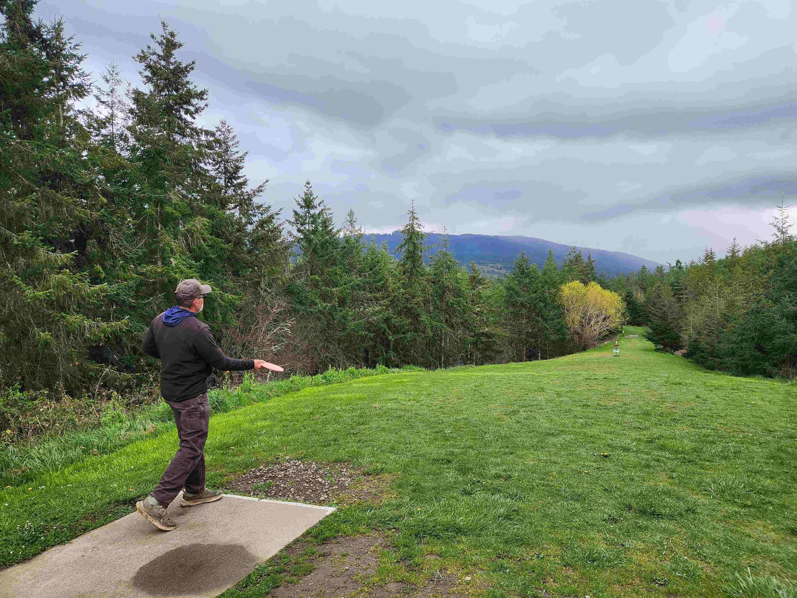 photo of person throwing disc at Rainshadow Disc Golf Park near Sequim, WA