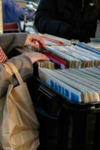photo of someone perusing through a bin of vinyl records during the Sequim Annual Record Show