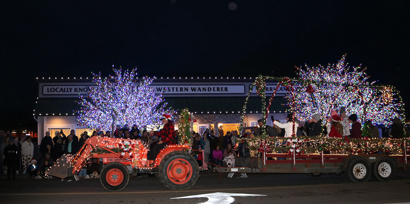 Photo of a tractor pulling a Christmas themed float during Sequim's annual Holiday Tractor Cruise on the Olympic Peninsula